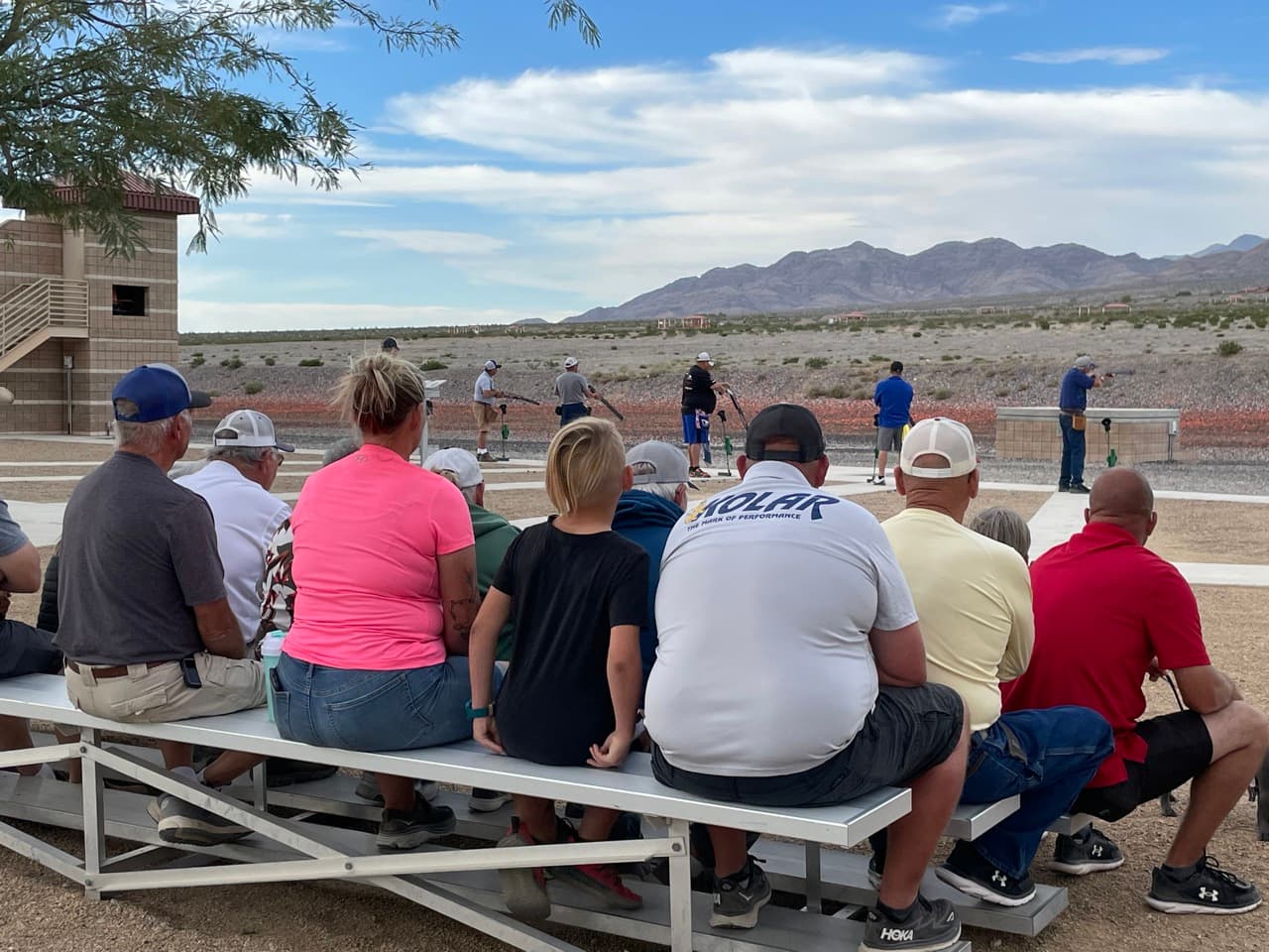 Spectators watching from bleachers with desert mountains at CCSC