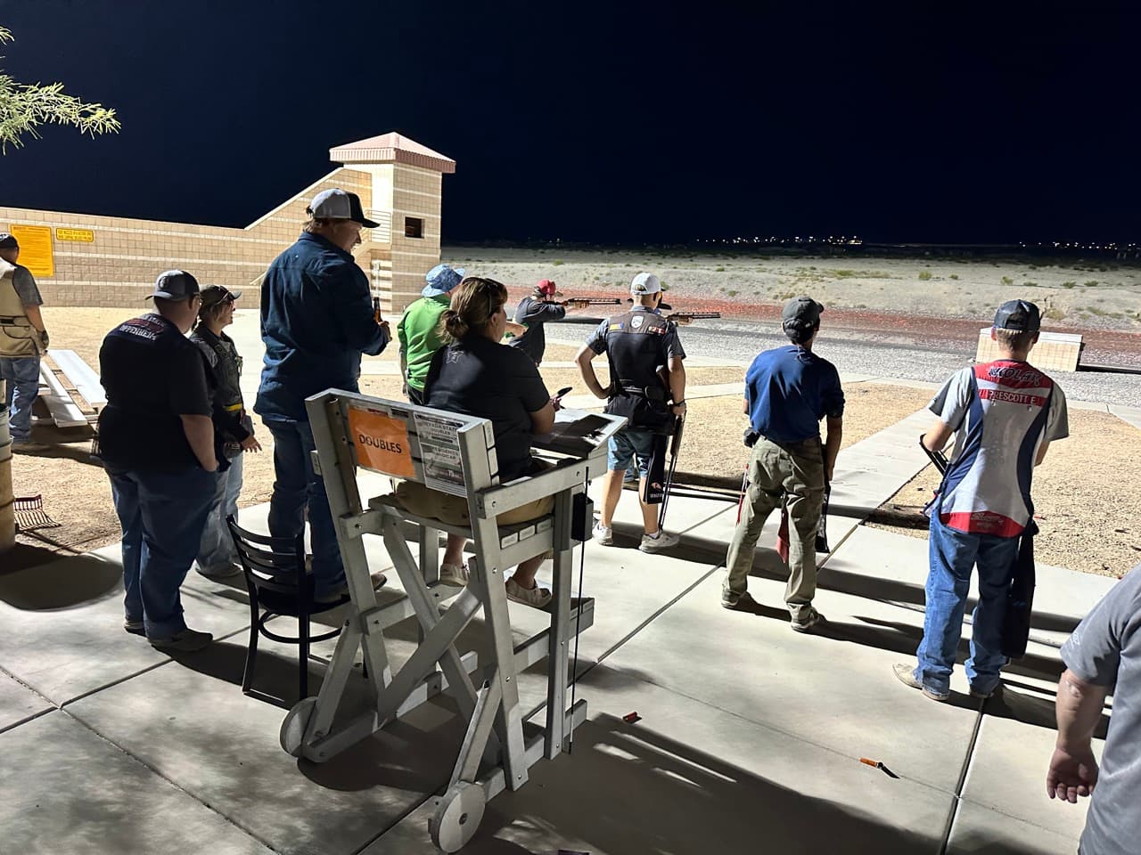 Shooters on the line at night at Clark County Shooting Complex