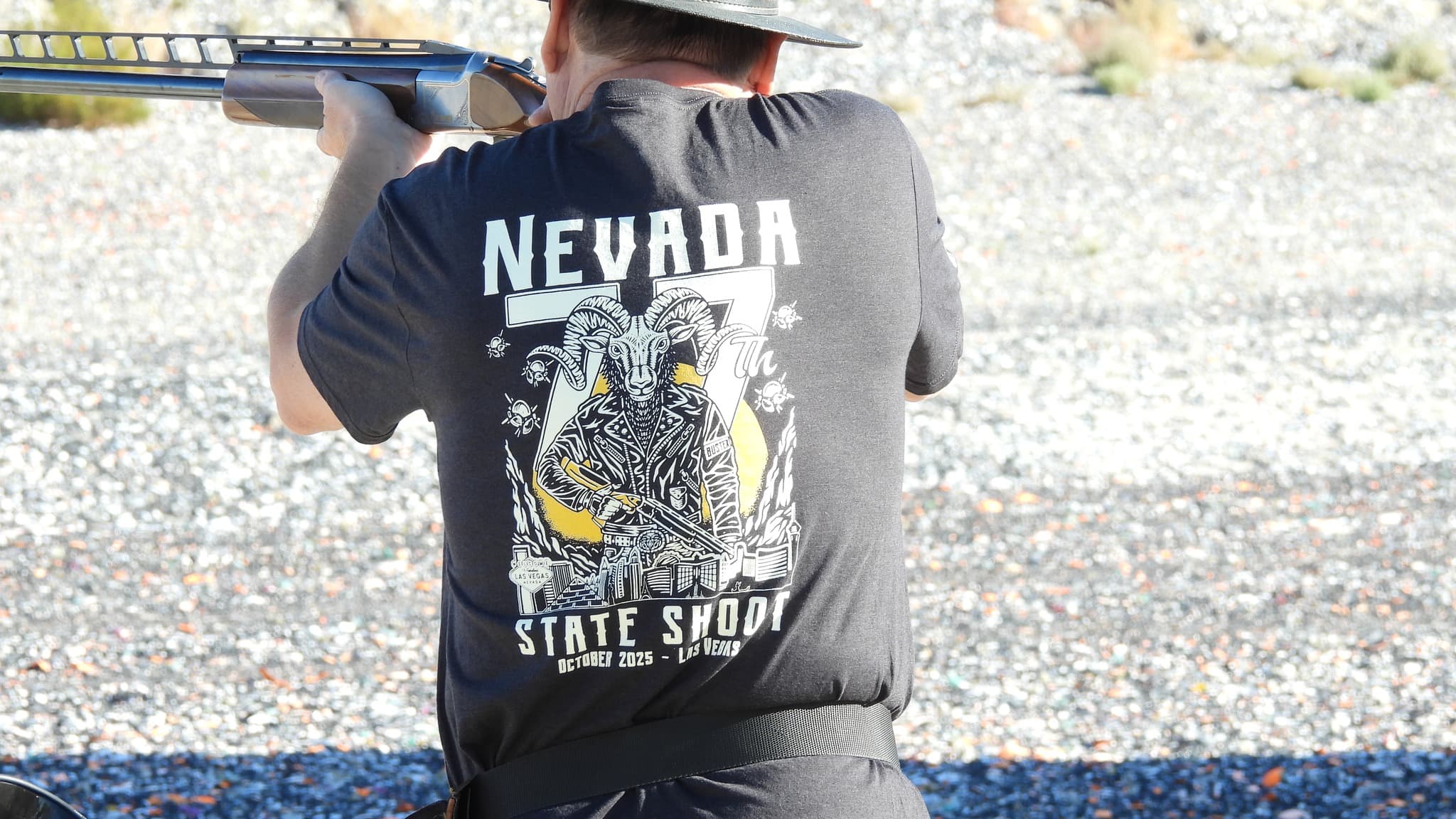 Shooter wearing Nevada State Shoot shirt, aiming downrange